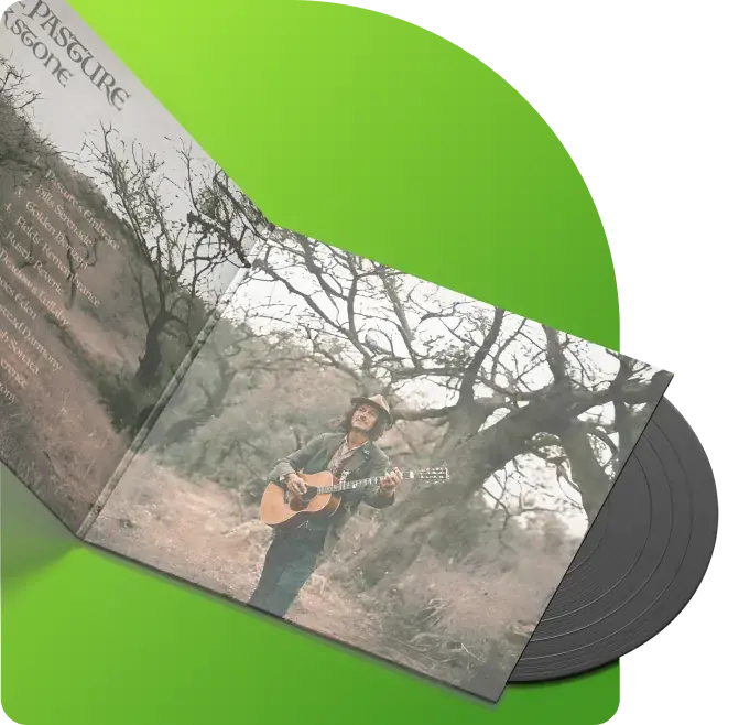 An open vinyl record album with the record partially visible. The album cover features a photograph of a person standing outdoors, holding a guitar. The background consists of leafless trees and dry grass. The left side of the album cover has text listing song titles and other information related to the album.